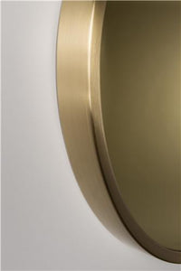 Tinted round mirror in gold