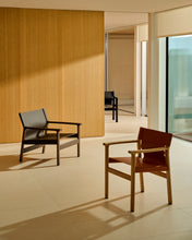 Load image into Gallery viewer, Jan armchair made of dark brown recycled leather fibres and FSC 100% solid ash wood with walnut-coloured finish - image 13