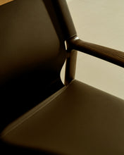 Load image into Gallery viewer, Jan armchair made of dark brown recycled leather fibres and FSC 100% solid ash wood with walnut-coloured finish - image 10